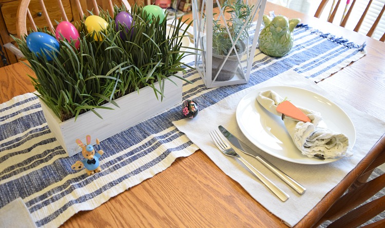 Centerpiece with faux potted grass and faux colorful Easter eggs