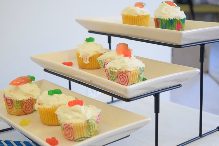 Three tiered serving tray with cupcakes decorated for spring and Easter