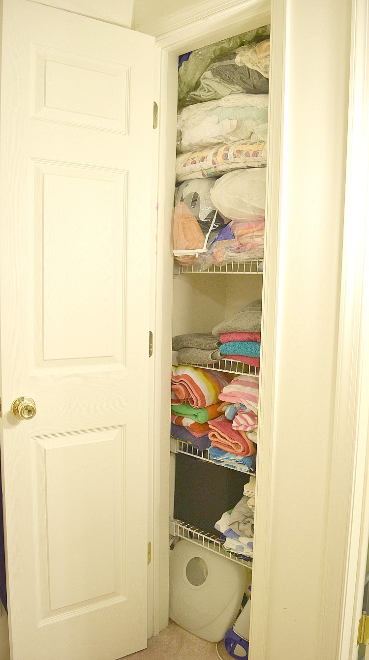 A linen closet organized with Ziploc space bags