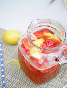 Fresh strawberries and lemons in a strawberry lemonade iced tea recipe