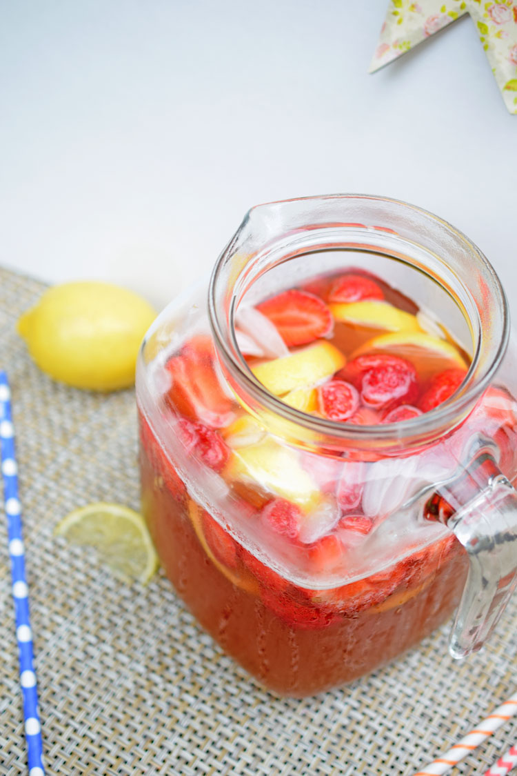 Fresh strawberries and lemons in a strawberry lemonade iced tea recipe