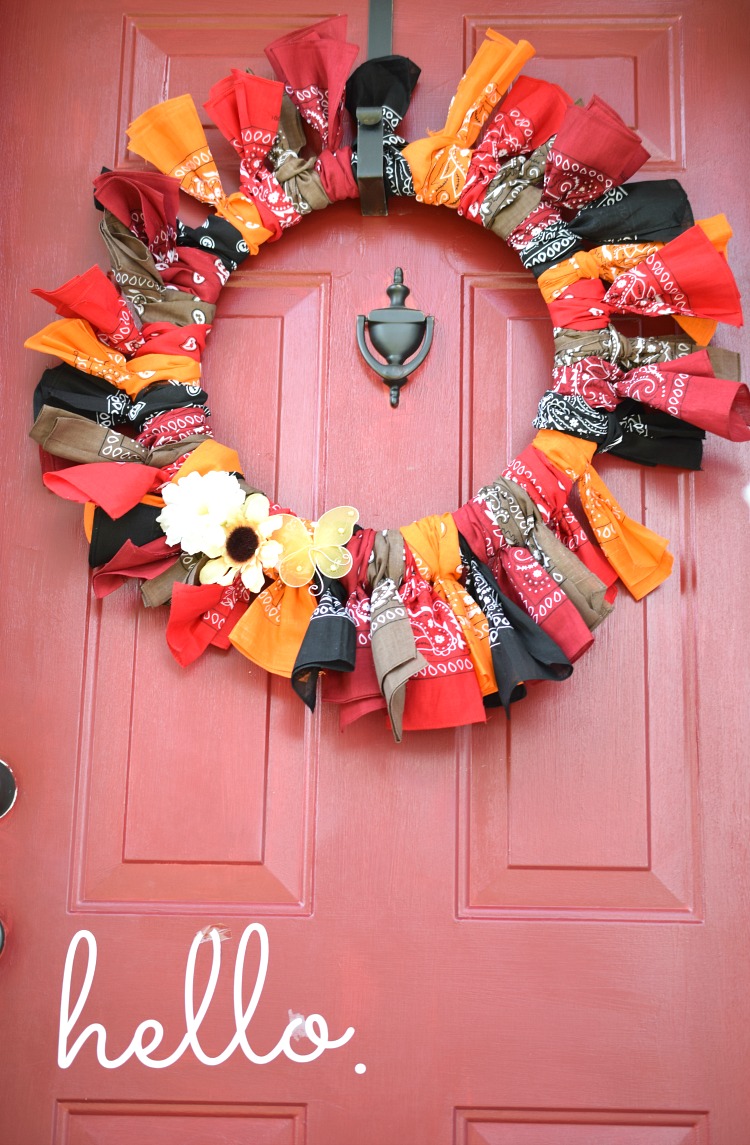 Colorful fall bandana wreath on a red front door
