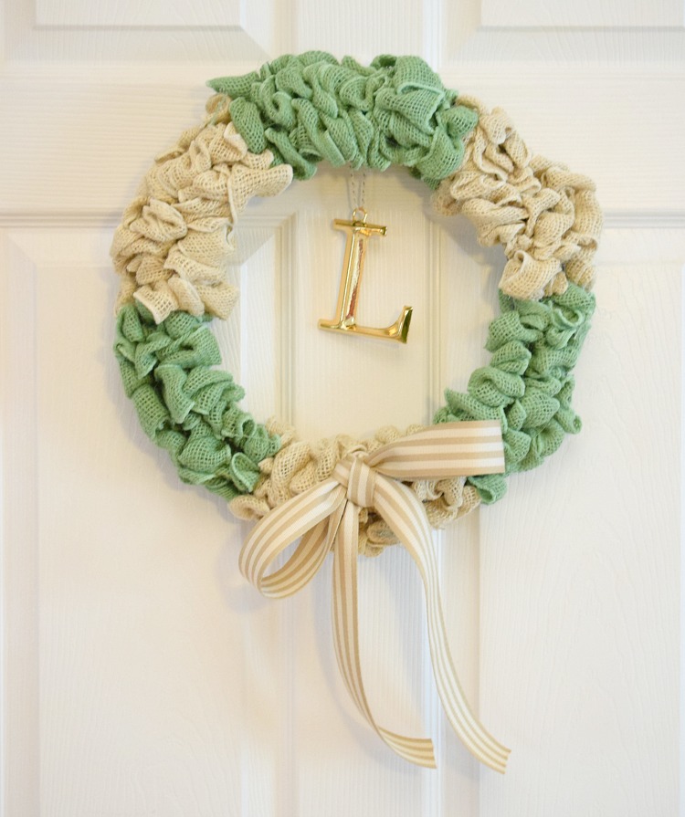 green and white burlap bubble wreath on a white door