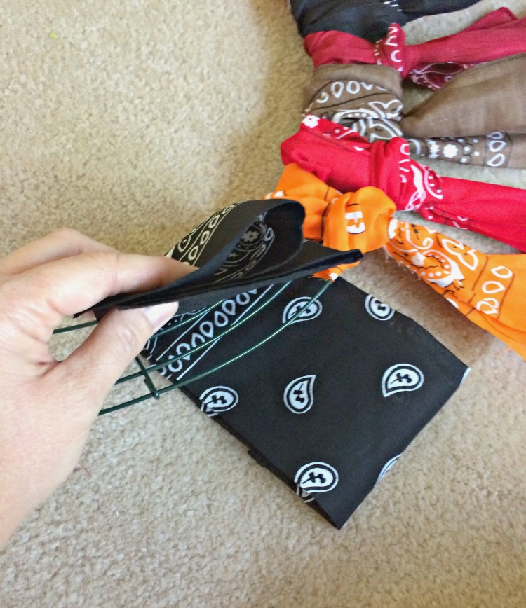 A beautiful bandana wreath can be made by tying bandanas onto a wire wreath form