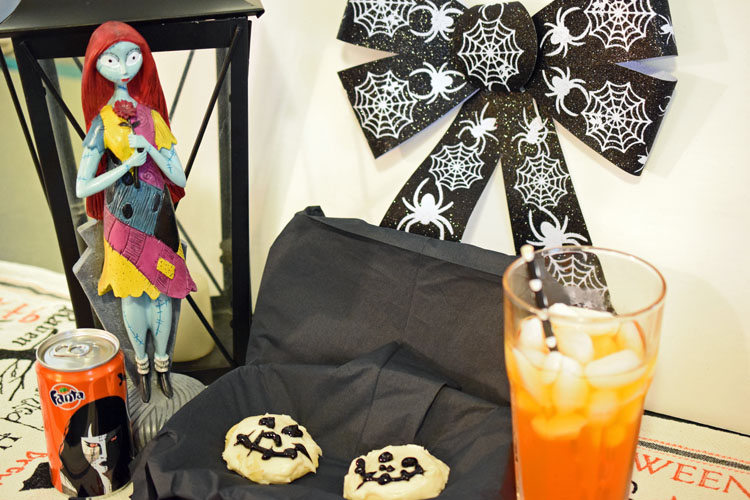 Halloween party spread with Jack Skellington sugar cookies with Fanta soda and Halloween decorations