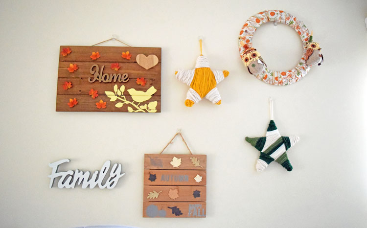 DIY fall gallery wreath with homemade signs, yarn wrapped stars and wreath