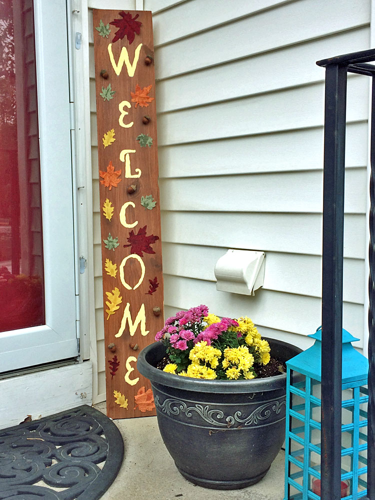 Fall porch decor with a DIY welcome sign, lantern and mums