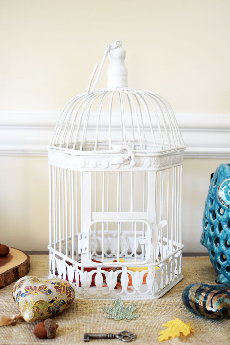 white metal birdcage on Oriental Trading on a fall console table