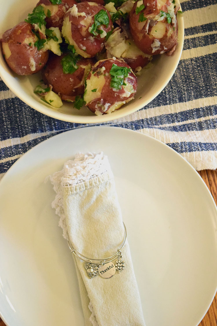 Thanksgiving table with bangle bracelet napkin rings and parsley red bliss potatoes