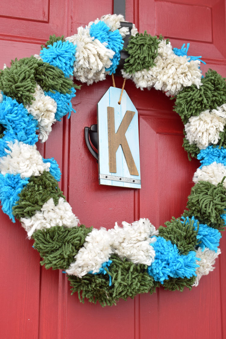 white, green and blue pom pom wreath for Christmas