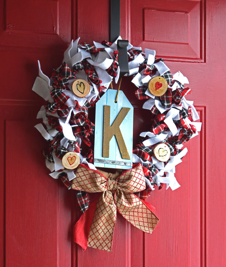 This wreath is easy to make with ribbon, strips of felt and wood slices.