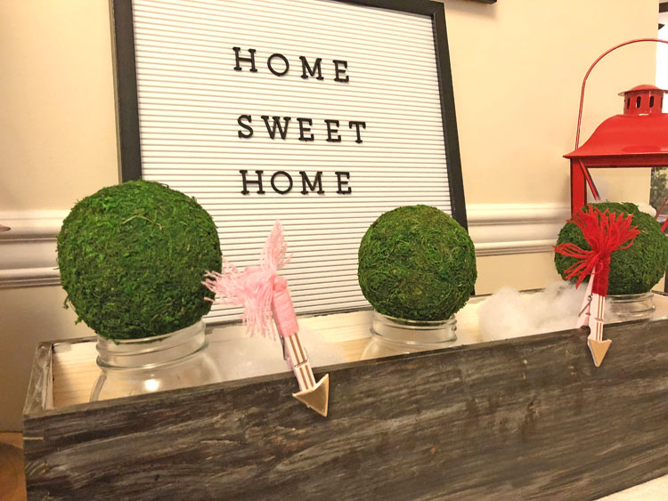 cute letter board on a Valentine's Day console table