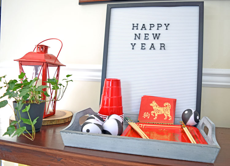 tall black and white letterboard with year of the dog decorations