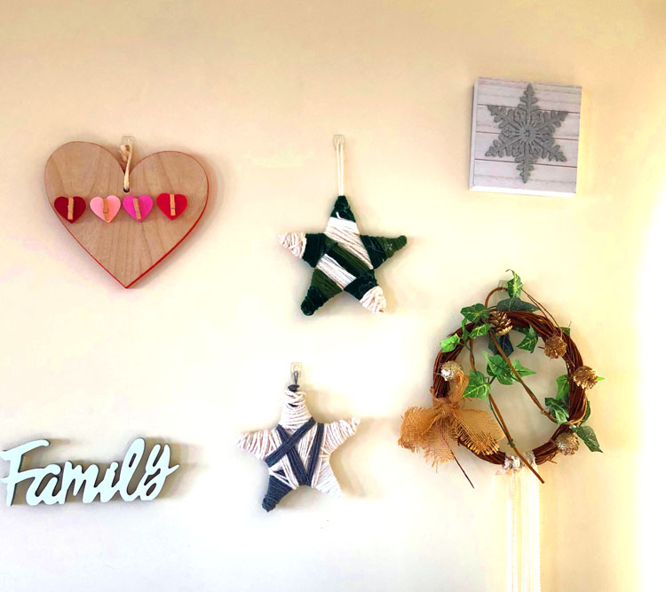 A living room gallery wall with many homemade items
