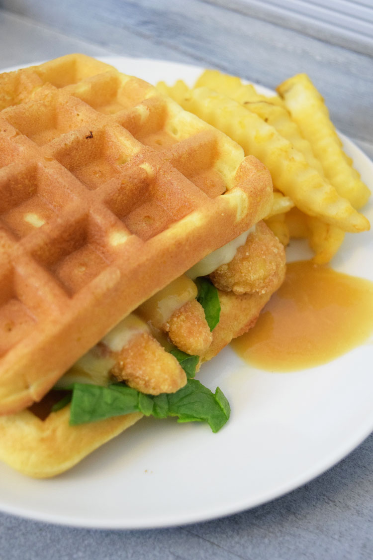 homemade chicken waffle sandwiches with pepper jack cheese, spinach and a maple honey mustard sauce