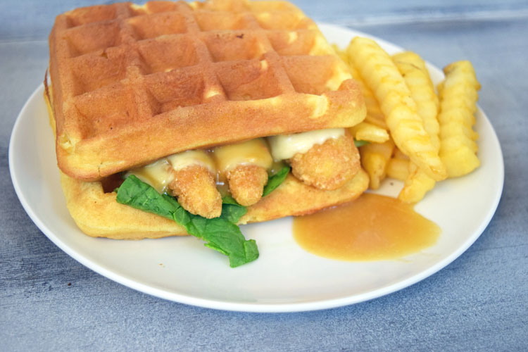 An easy and fun dinner recipe for a chicken and waffles sandwich with pepper jack cheese and a maple honey mustard sauce