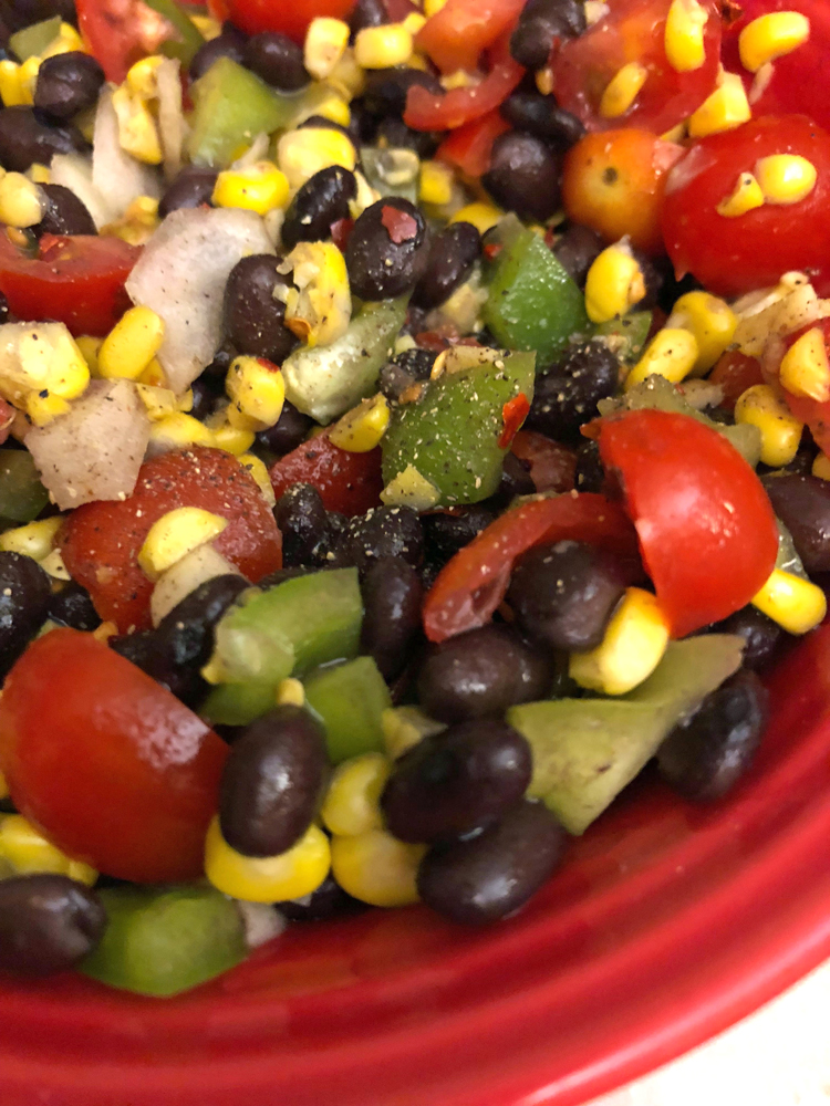 A recipe for black bean salsa made with beans, green peppers, tomatoes and onion.