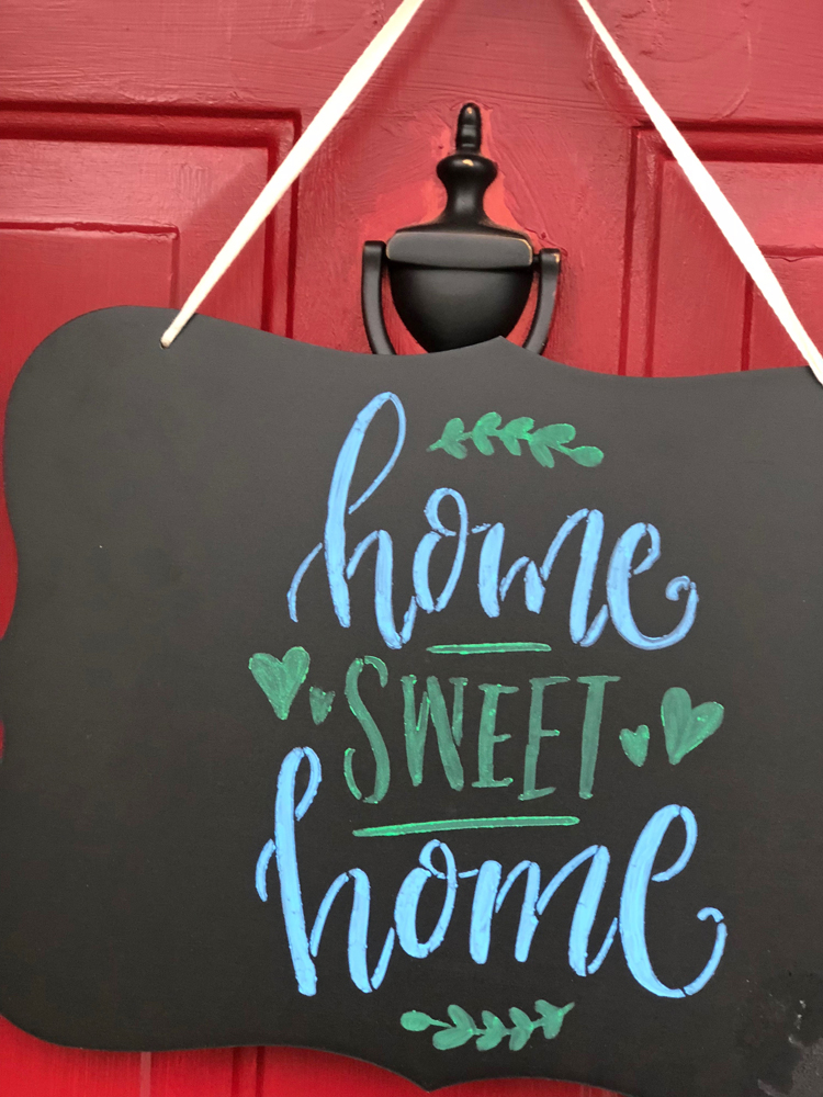 A beautiful Home Sweet Home chalkboard sign made for a front door with some liquid chalk markers and a stencil from Stencil Revolution