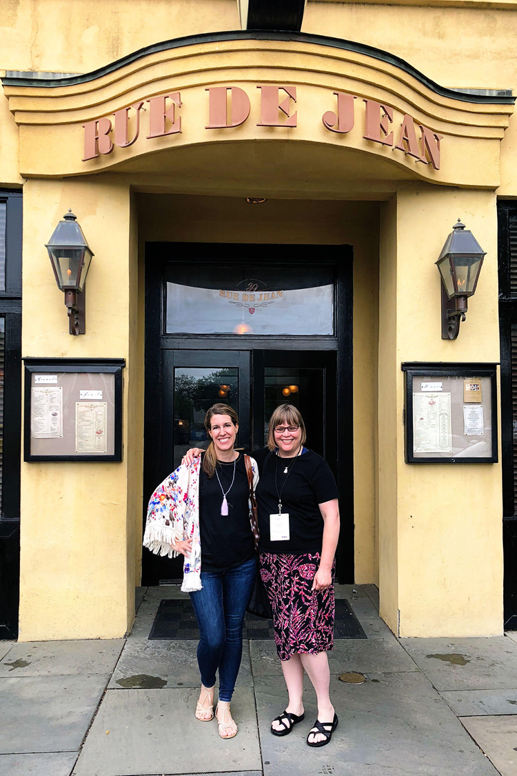 Lauren of Mom Home Guide and Carrie of Curly Crafty Mom in front of French restaurant 39 Rue de Jean in Charleston, S.C.