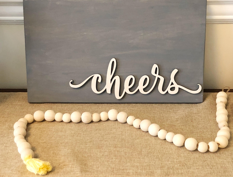 farmhouse console table with diy sign and beaded garland