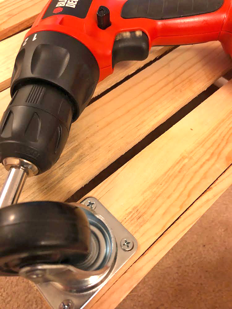 how to attach caster wheels to a wood crate to make a rolling magazine cart