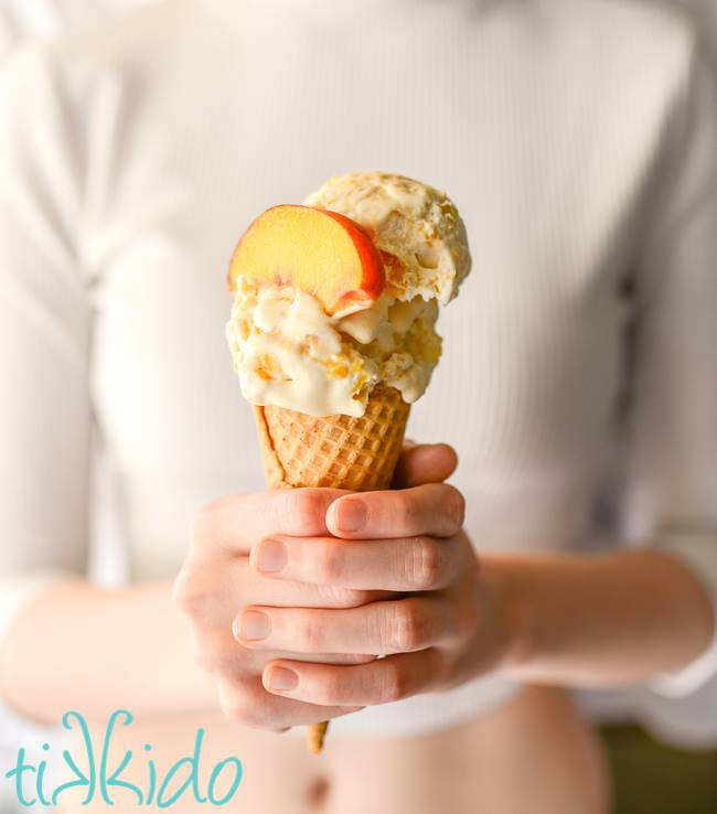 recipe :woman holding a cone of no churn peach ice cream
