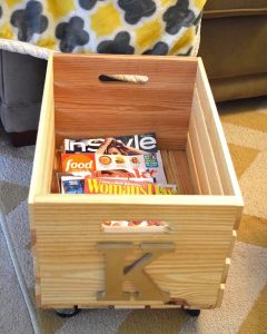 wood crate on wheels holding magazines