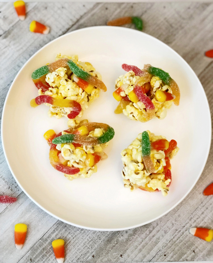 easy marshmallow popcorn balls with gummy worms and candy corn