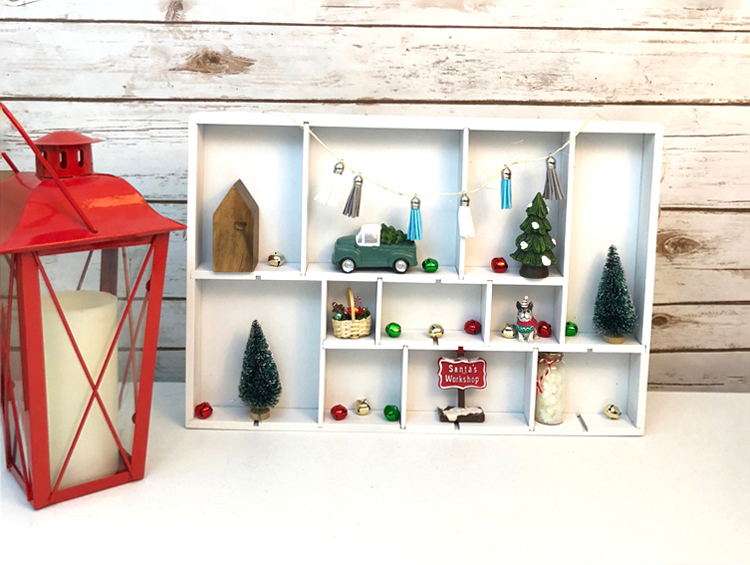 I love this easy DIY white shadowbox display case for sweet Christmas village miniatures.