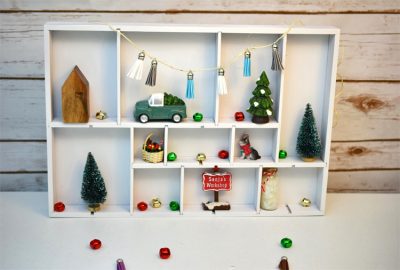 I love how my spray painted drawer organizer turned Christmas shadow and curio box turned out! It gives me a fun place to display lots of fun Christmas miniature figurines. There are so many cute ones at the craft store.