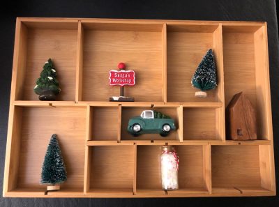 I love how a simple drawer organizer can be turned into a shadow or curio box for displaying Christmas and holiday miniature figurines.