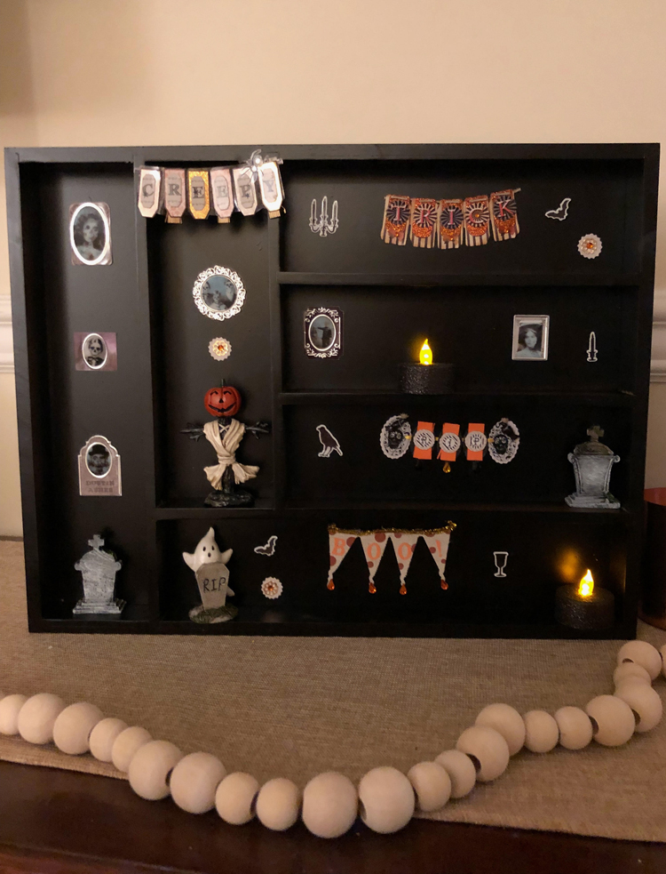 This easy to make and inexpensive DIY Halloween shadow box and display curio case looks great on a console table.