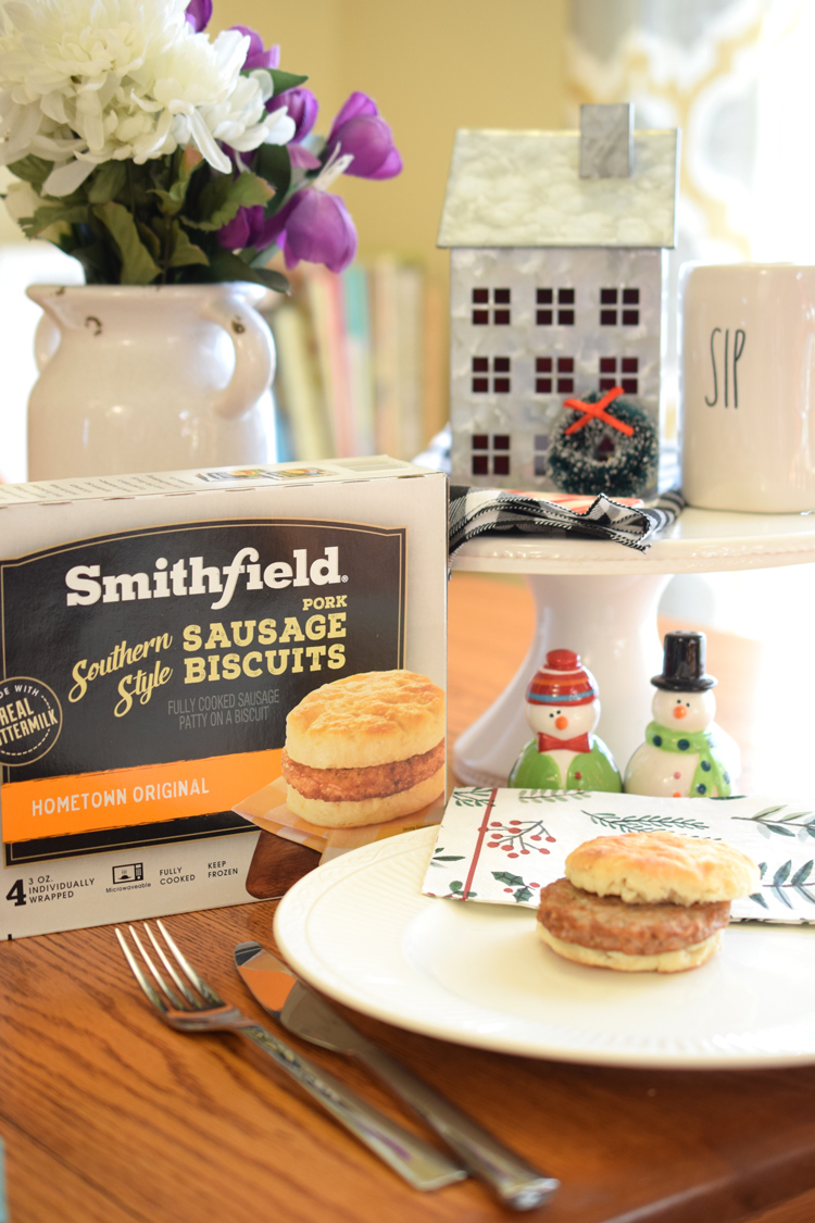 Breakfast table set with flowers, snowmen salt and pepper shakers and Smithfield breakfast sandwiches