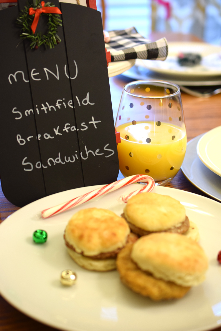 Adorable breakfast table with chalkboard menu, breakfast sandwiches and juice
