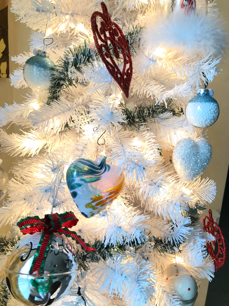 white Christmas tree with colorful heart ornaments