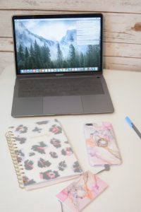 MacBook Air with an iPhone 8 Plus in a Violet Sky case with portable phone bank charger from Velvet Caviar