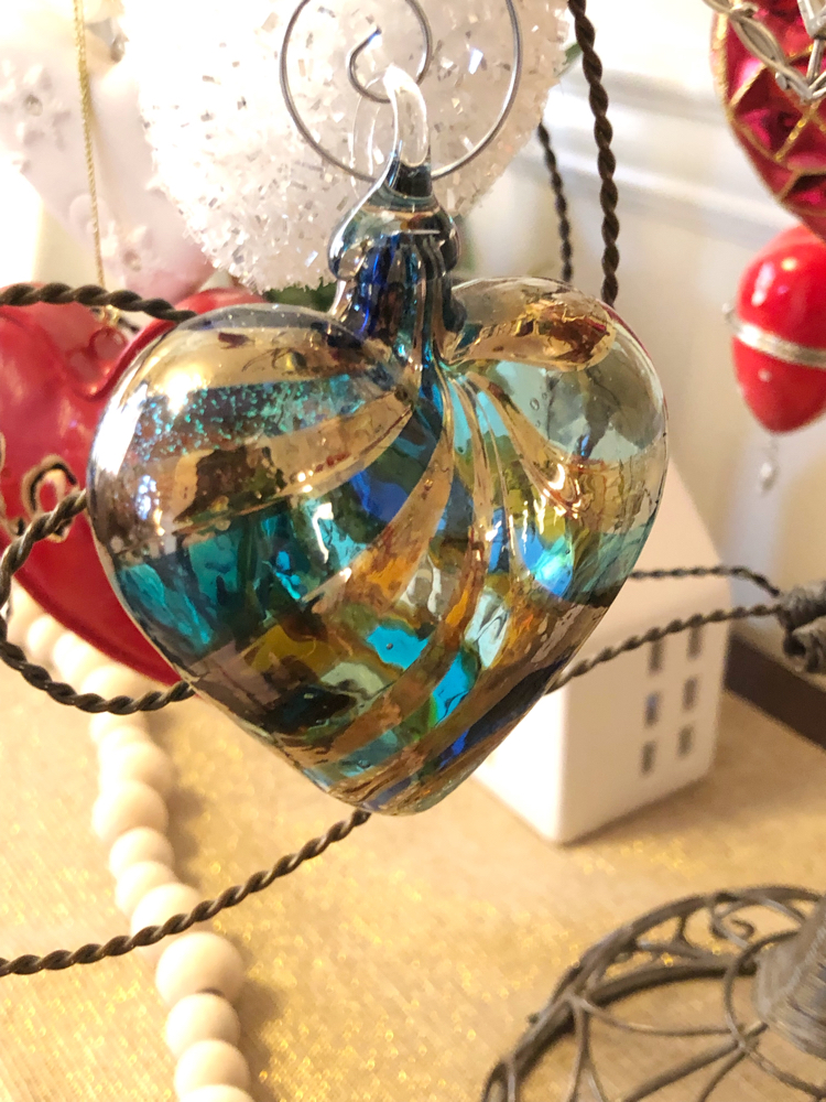 A glass heart ornament on a Valentine's Day ornament tree