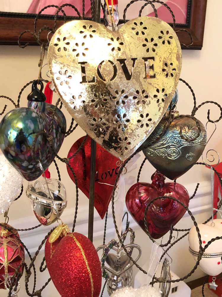 gold heart ornament on a ornament tree filled with heart ornaments for Valentine's Day