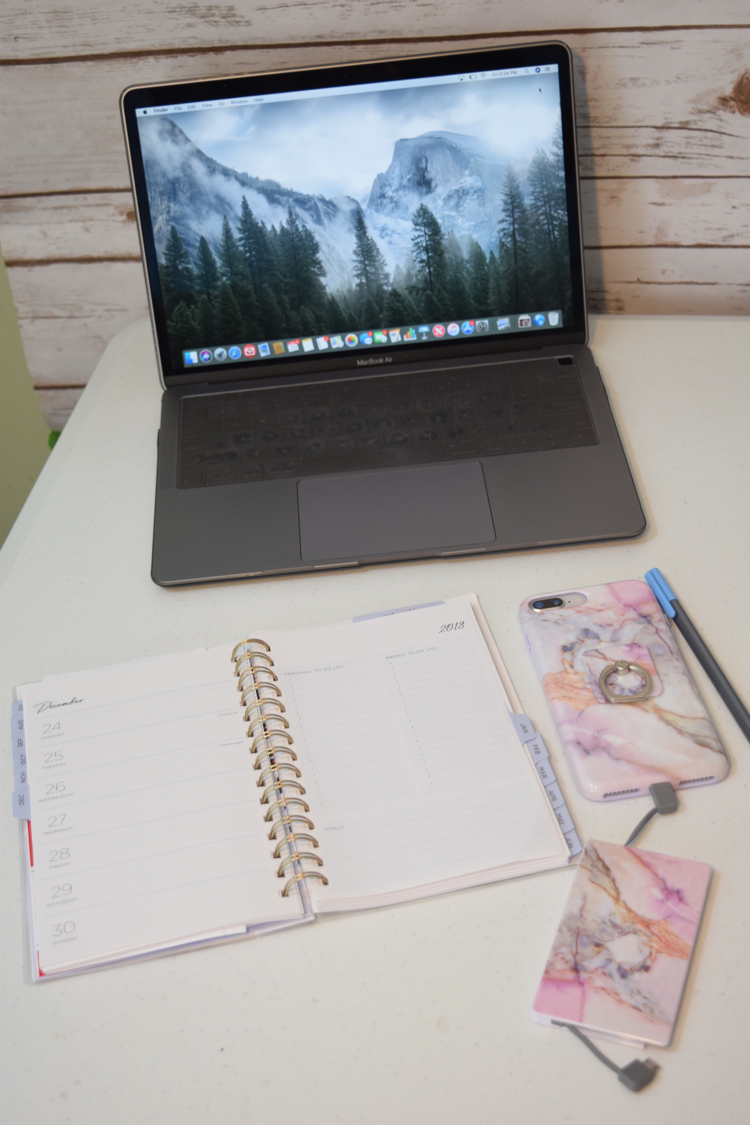 MacBook Air with iPhone 8 Plus with a marble phone case and portable phone bank charger