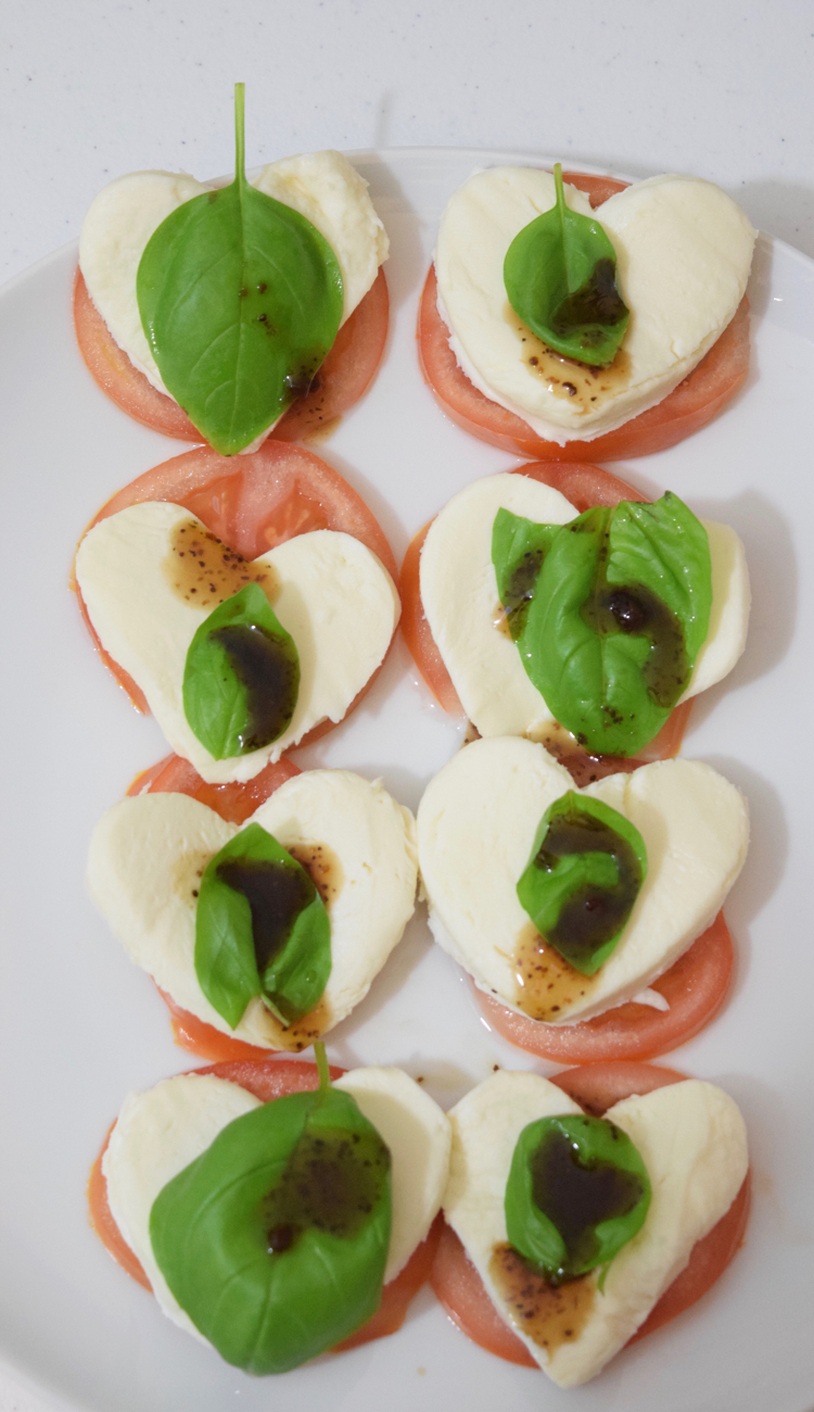 Caprese salad with mozzarella, tomato, basil and balsamic vinegar for Valentine's Day