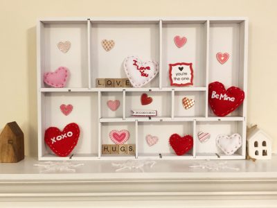 A DIY Valentine's Day display box made from a spray painted drawer organizer
