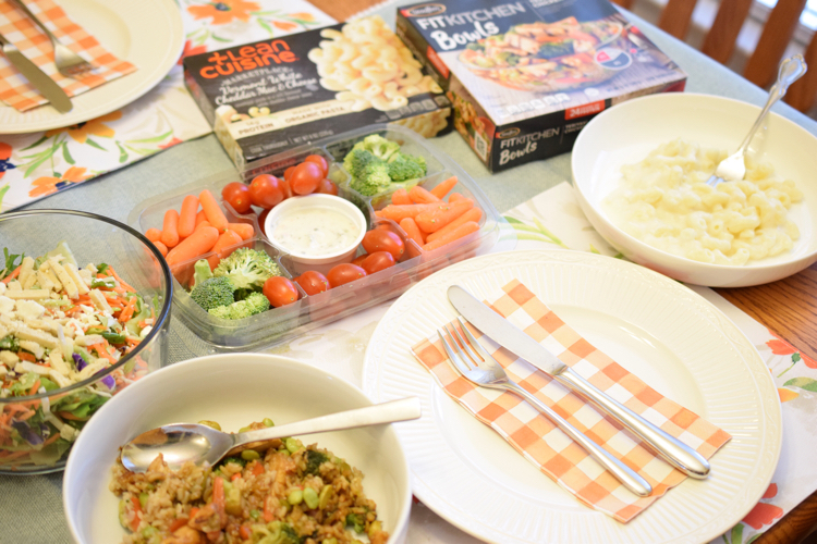 A pretty spring table set with fresh vegetables, salad and Lean Cuisine and Stouffer's entrees.