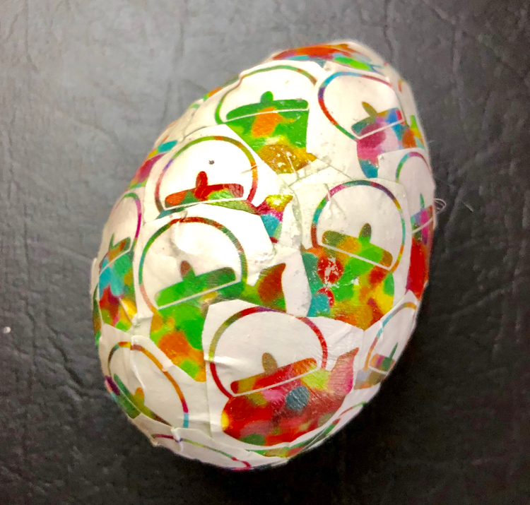 A craft Easter egg decoupaged with origami paper and Mod Podge