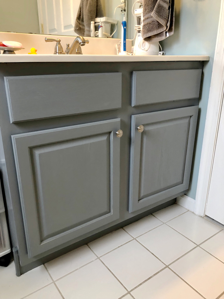 I love how this oak bathroom cabinet was painted in Satin Enamels Smoke Grey paint by Americana Decor.