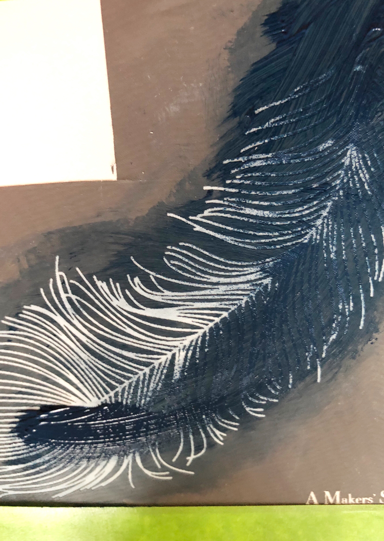 blue paint on a feather stencil