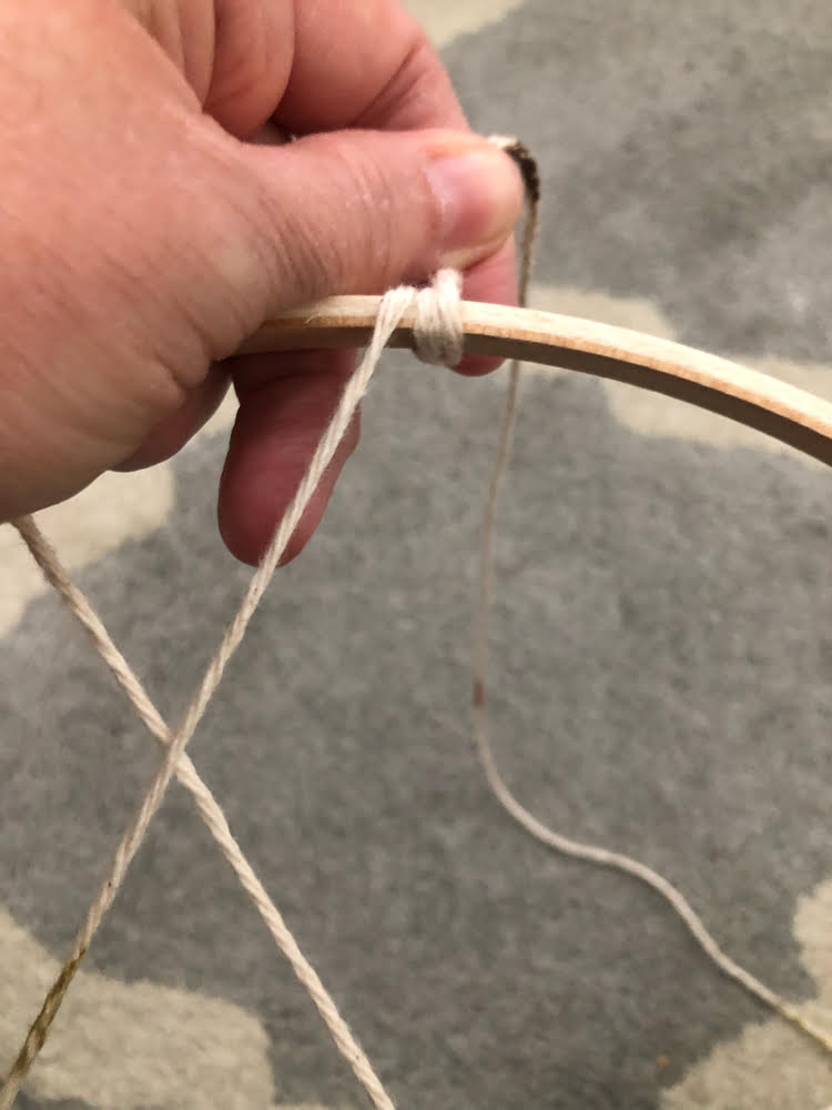 wrapping yarn around an embroidery hoop to create a dream catcher