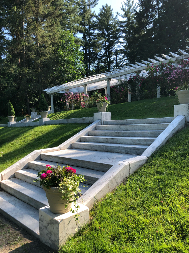A beautiful pergola planted with roses at Yaddo Gardens in Saratoga Springs, NY