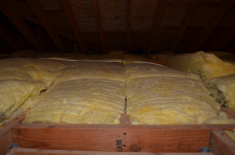 A closeup look of our attic before we put in easy to install Attic Dek flooring