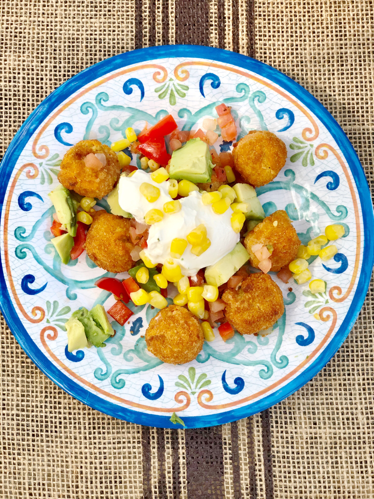 McCain Veggie Taters served with chopped tomatoes, avocado and red peppers. Also topped with corn and sour cream.