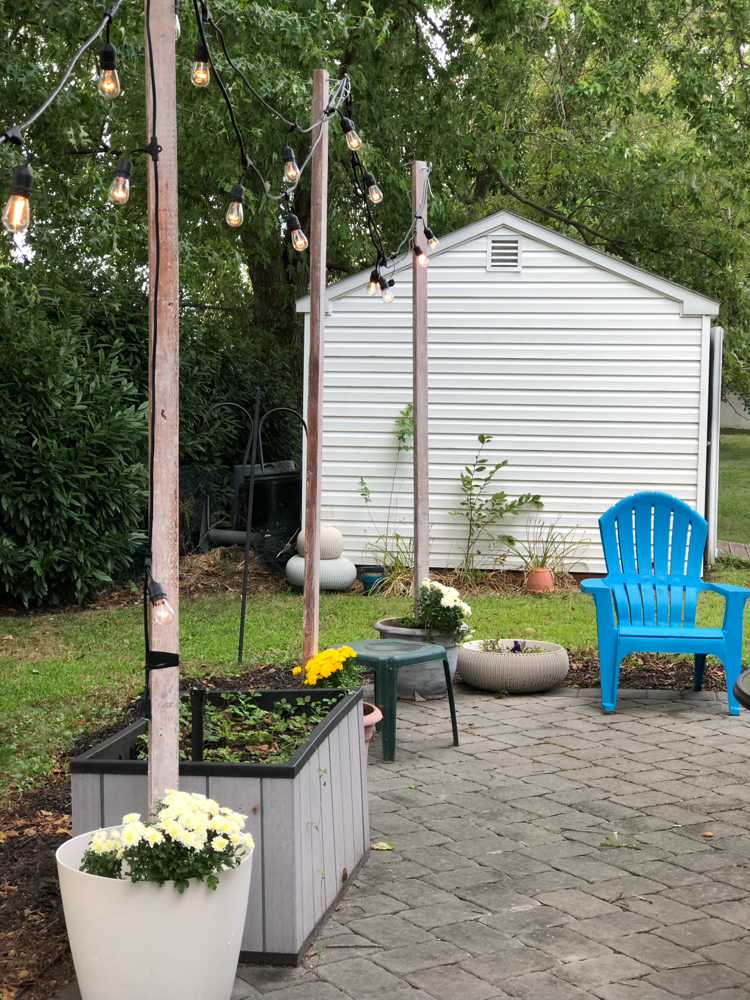 How to hang string lights on a patio from DIY planter string light posts.